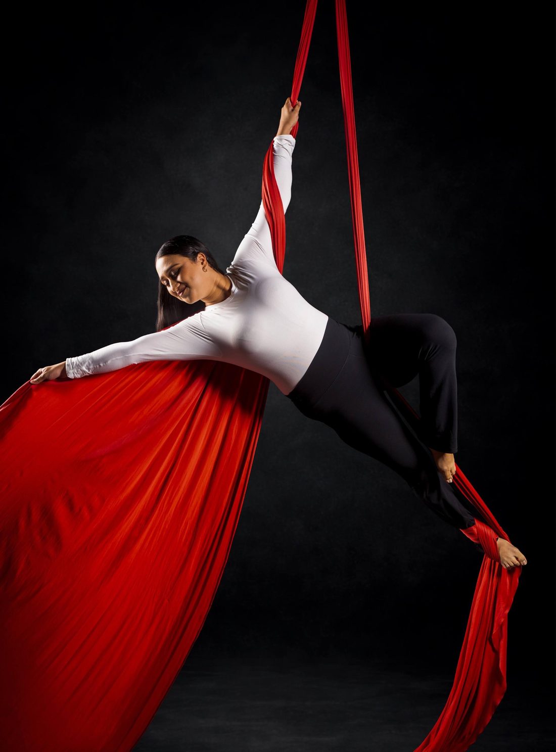 Bushranaaz, Assistant Teacher, in a pose on red aerial silks